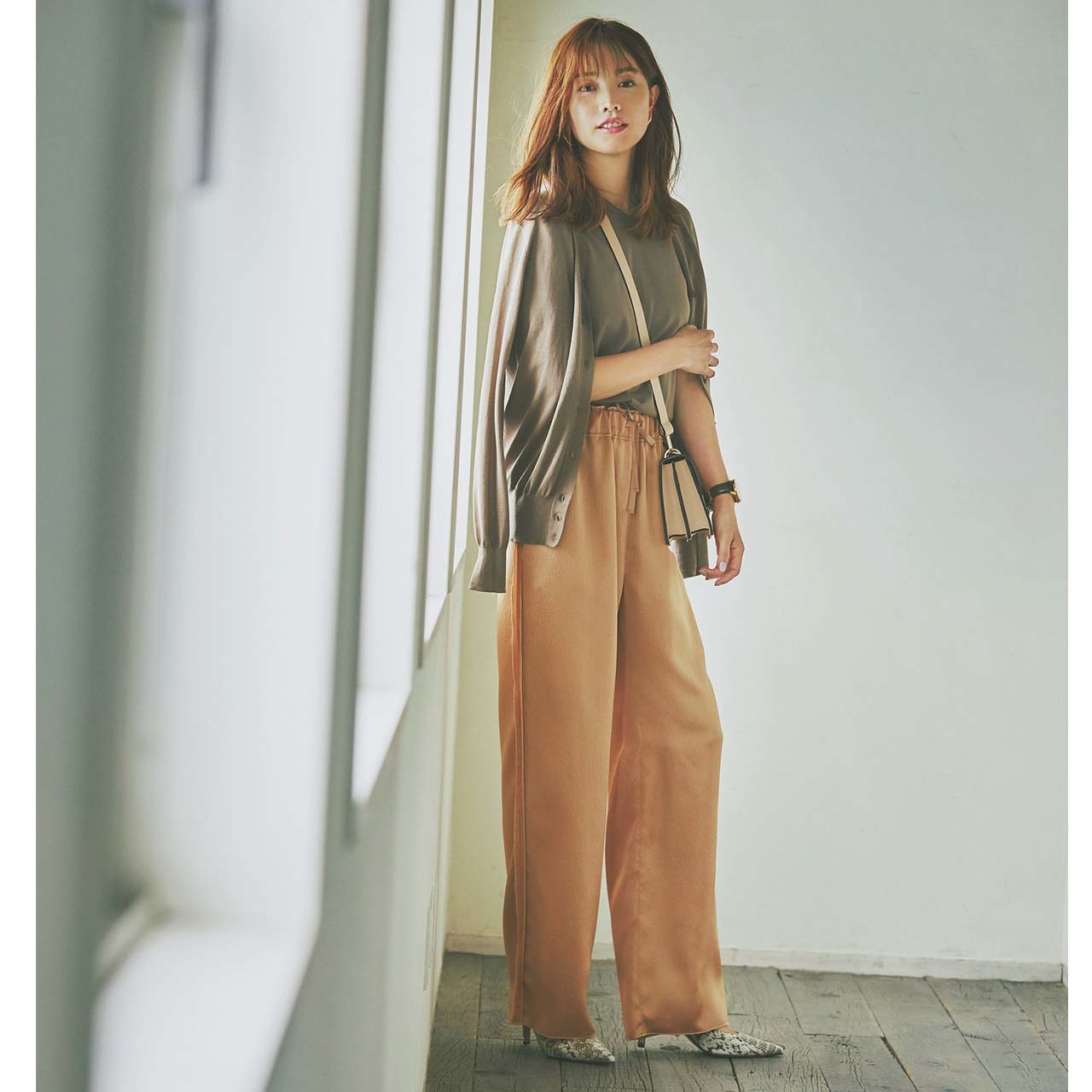 ブラウンニット×ペールオレンジのパンツコーデを着たモデルの蛯原友里さん